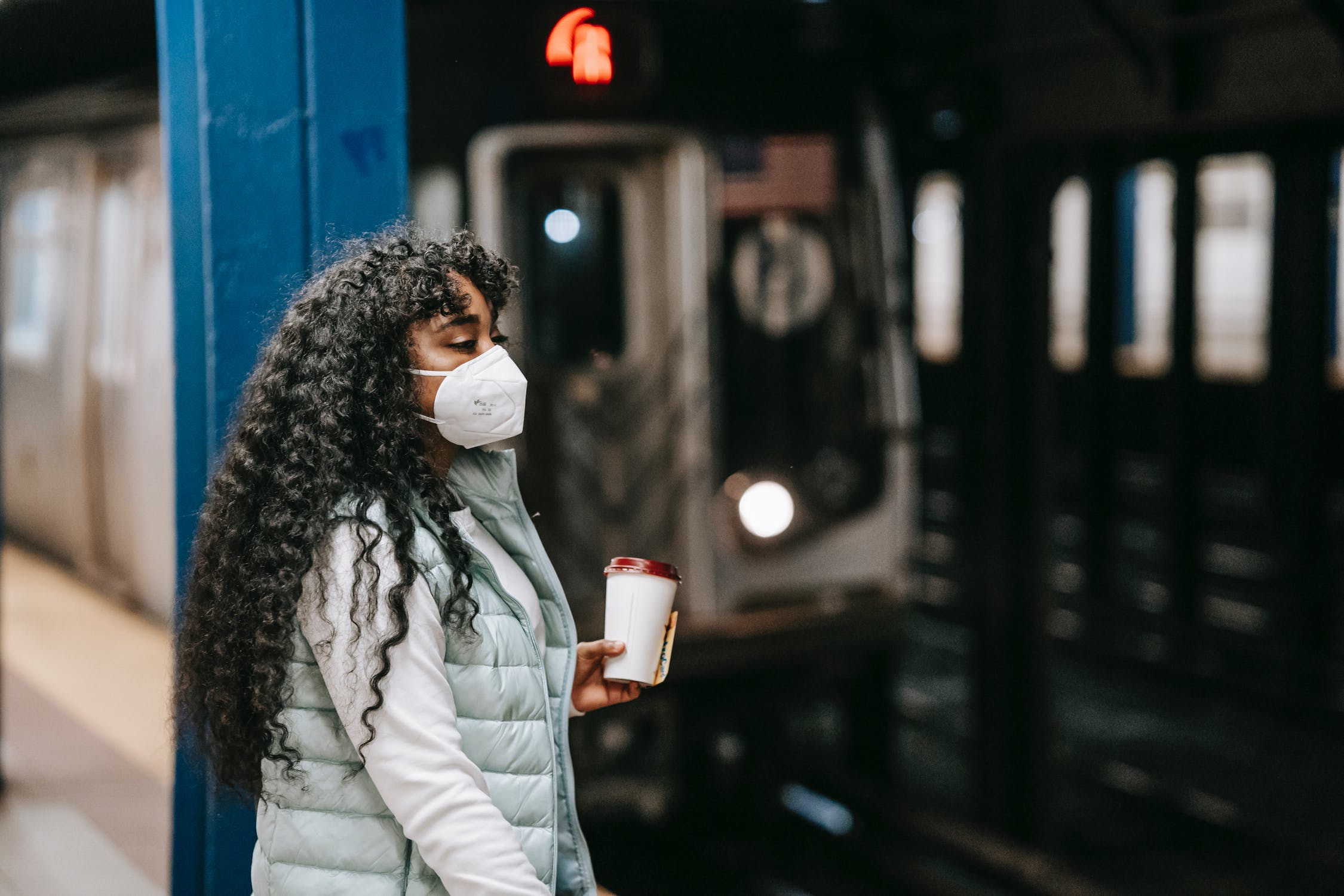 Black woman standing on metro platform