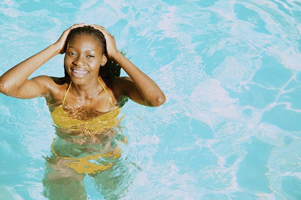 Young Woman in Swimming Pool Smiling
