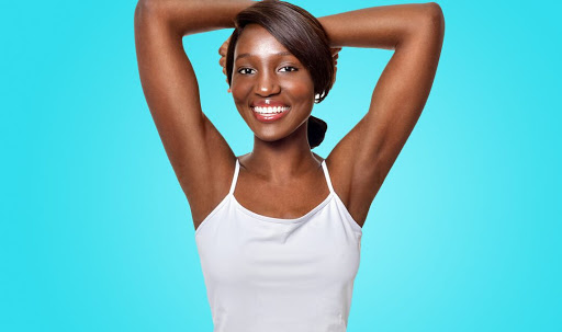 black woman raising arms for laser hair removal treatment