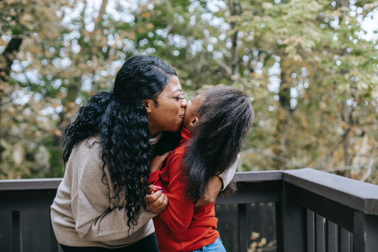 black mom hugging child with special needs